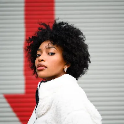 Original reference image for: AI generated image: A professional photorealistic shot of a physical vinyl record sleeve resting on a luxurious green ma